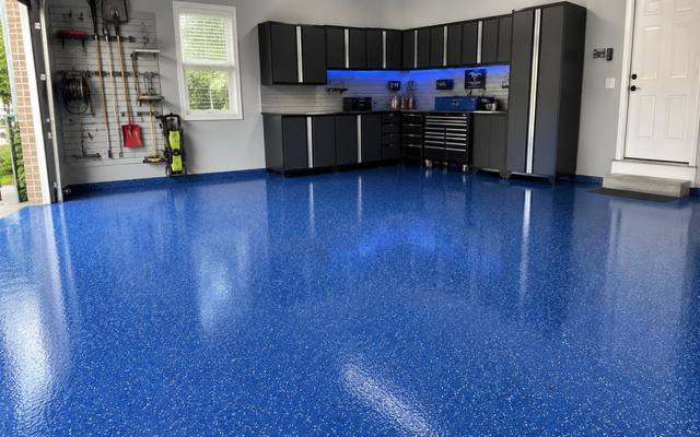 Blue speckled epoxy floor in a garage with black cabinets in Waterloo Region